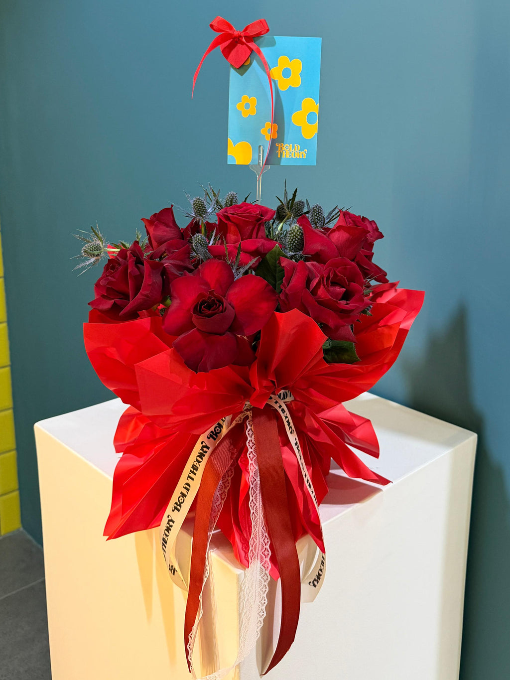 Lady in Red red rose bouquet with statement bow and ribbon accents