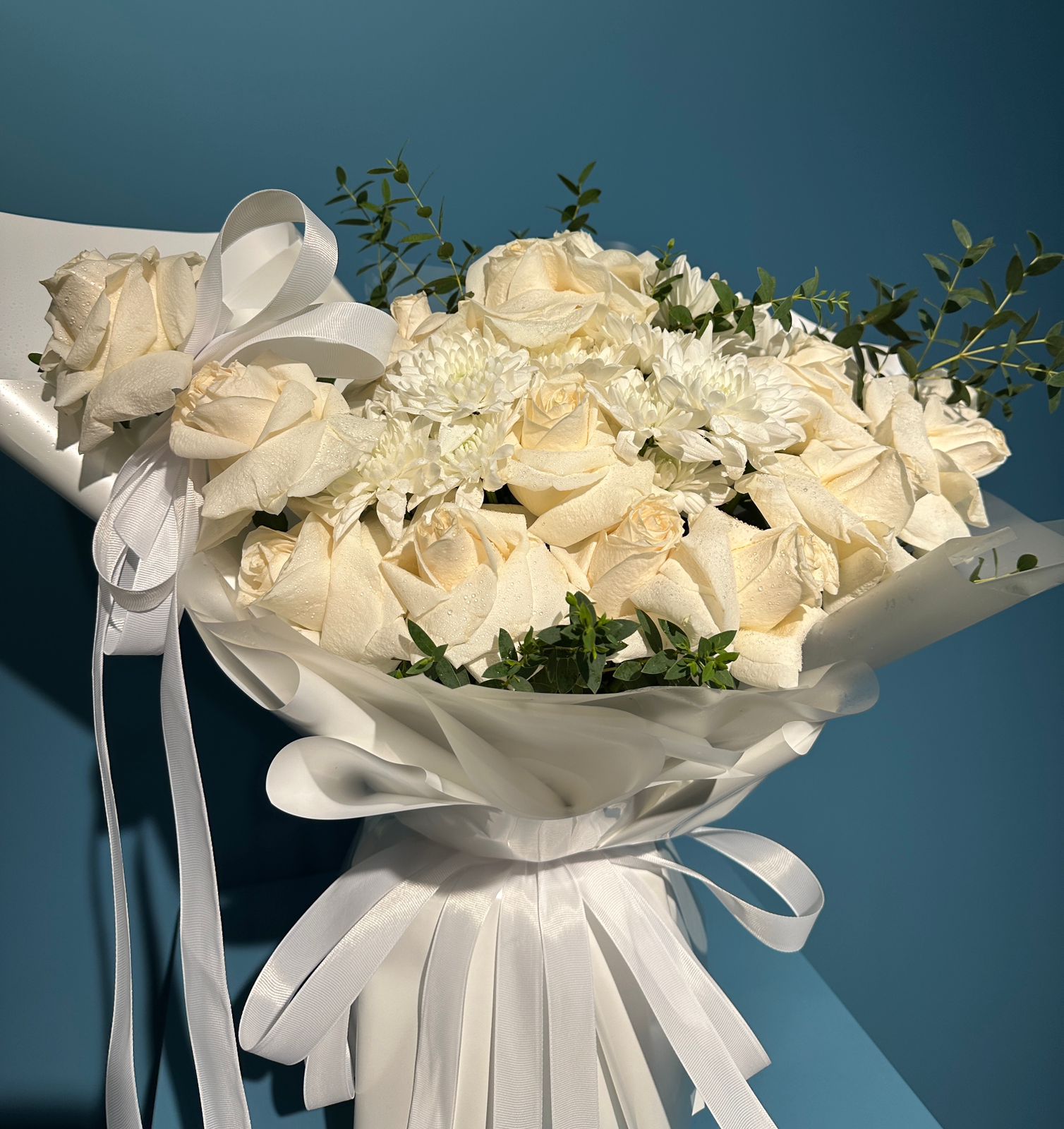 Porcelain white rose bouquet with chrysanthemums and eucalyptus